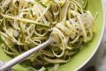 Zucchini Noodles on a green bowl with a fork