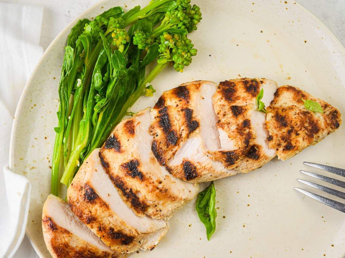 Grilled Chicken Breast with Basil and Broccolini on a plate.