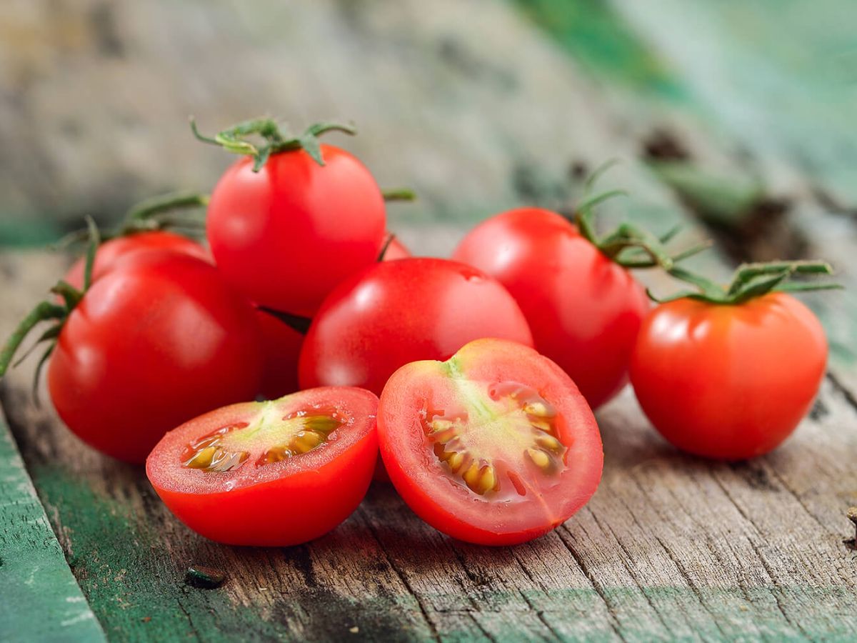 Fresh, ripe cherry tomatoes on a wood table