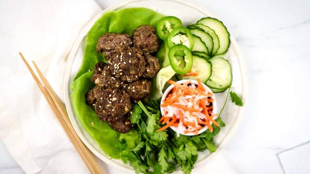 Asian meatballs with cucumbers, pickled carrots, and lettuce wraps.