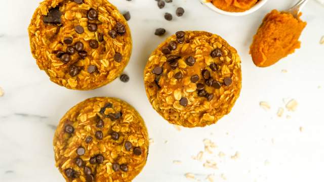 Baked pumpkin oatmeal with chocolate chips and a spoon of pumpkin.