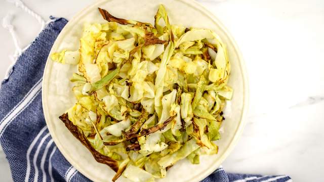 Roasted cabbage in pieces with browned edges on a plate.