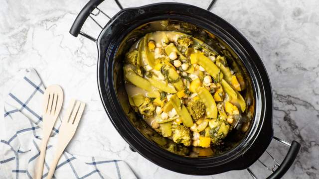 Slow cooker Curry Chickpeas with Vegetables in a black crockpot.