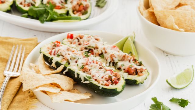Turkey Fajita Zucchini Boats with ground turkey, pepper, onions, and tomatoes in hollowed out zucchini with melted cheese.